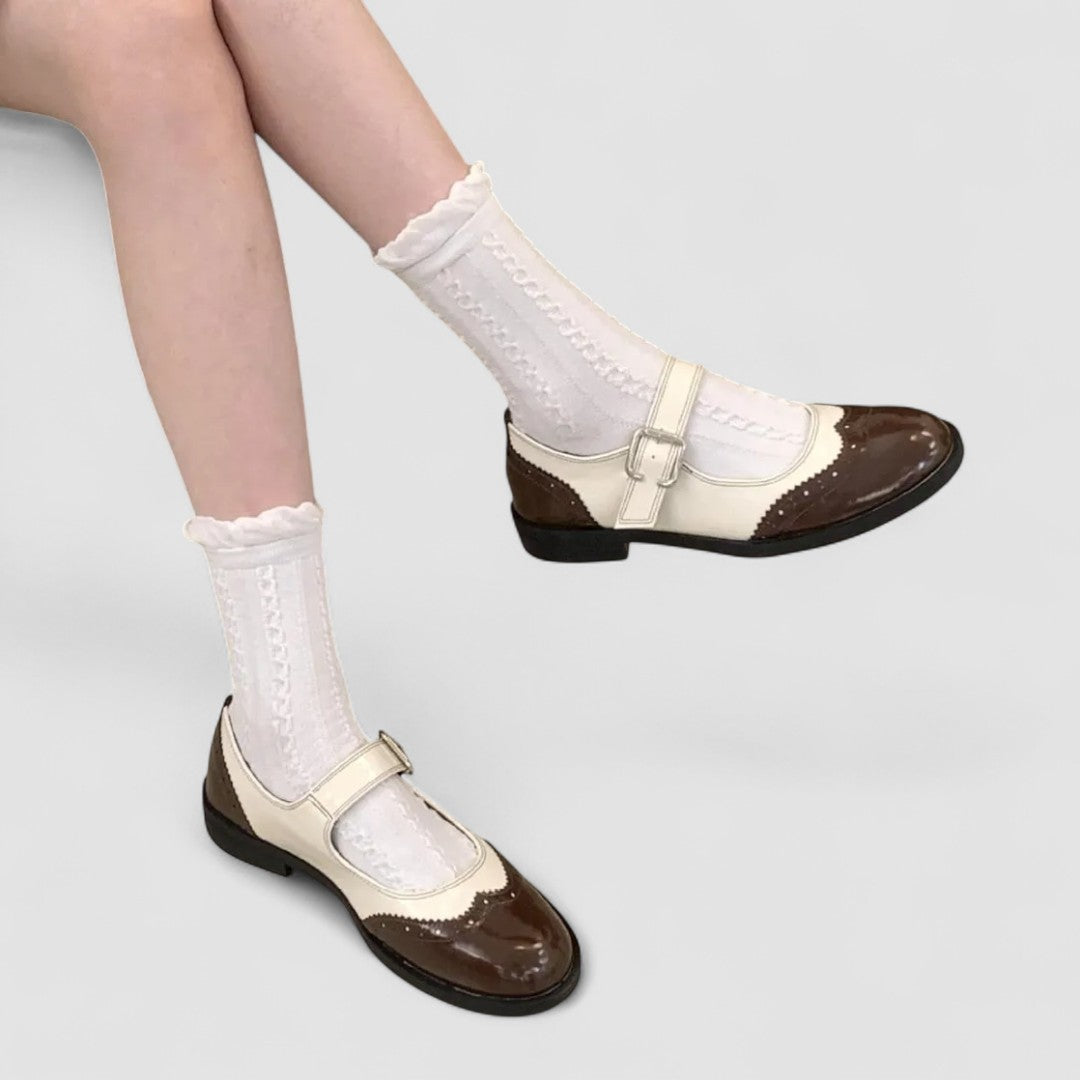 Top-down view of stylish women's flat shoes highlighting the adjustable buckle strap detail.