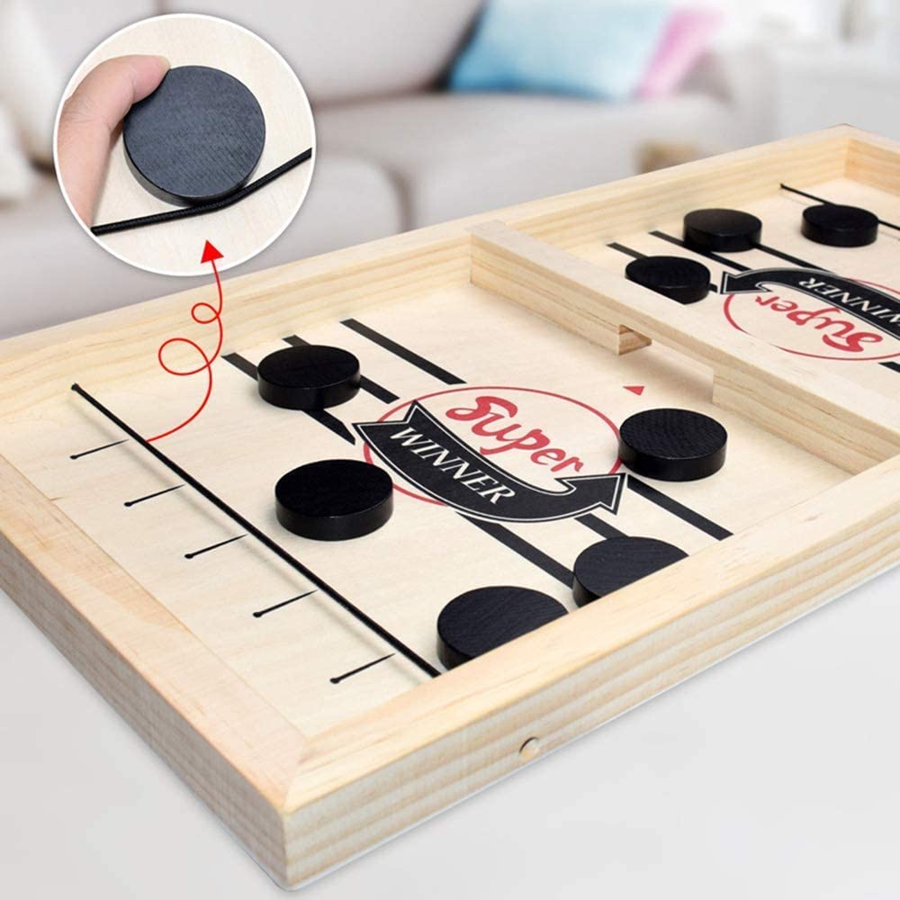 Detailed view of the wooden sling hockey board with black playing pucks