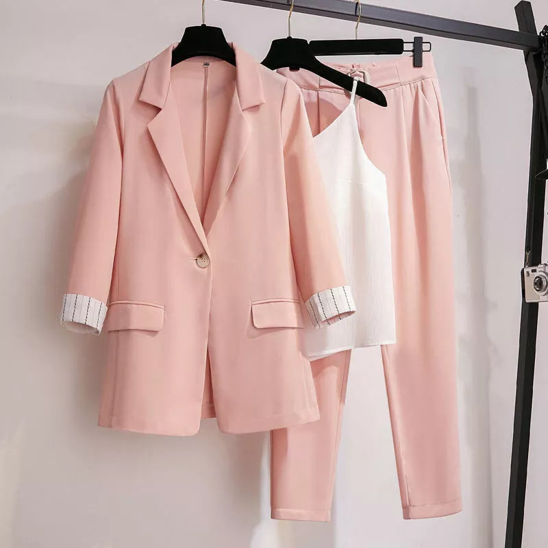 Pink women's three-piece blazer suit set with matching trousers and top
