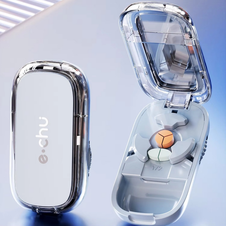 Portable medication organizer and pill cutter shown from an angled perspective on a flat surface.
