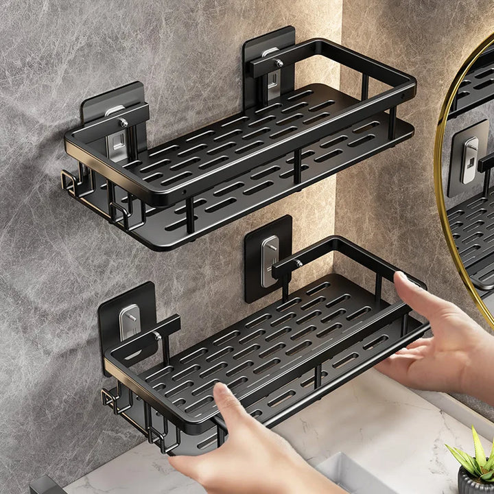 Black wall-mounted bathroom storage shelf mounted on tiled wall