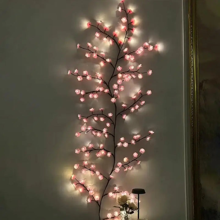 Vertical display of cherry blossom LED string lights mounted straight on an interior wall