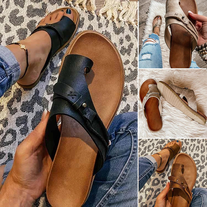 Women wearing black and beige toe loop sandals with cushioned footbeds