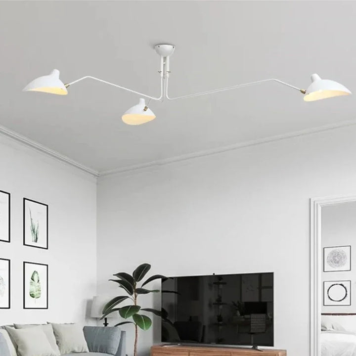 Modern white ceiling lamp with adjustable reflectors mounted on a bright white ceiling