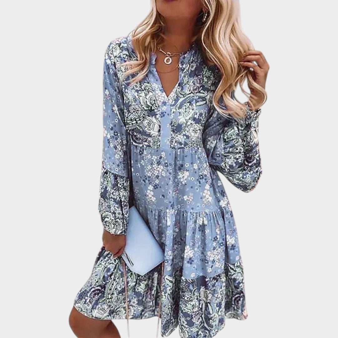 Woman wearing light blue floral boho mini dress with V-neckline