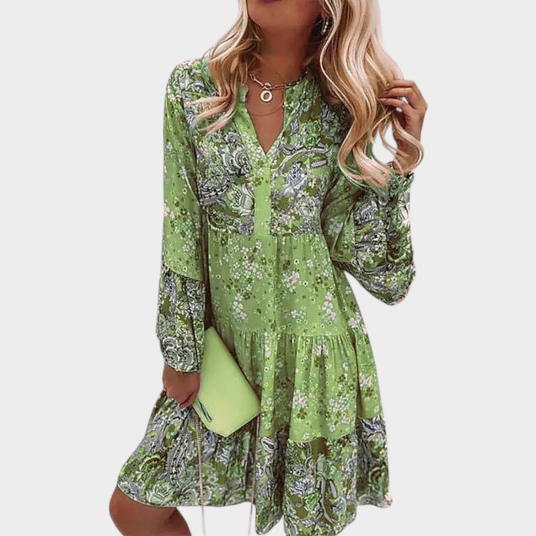 Woman wearing green floral boho mini dress with long flared sleeves