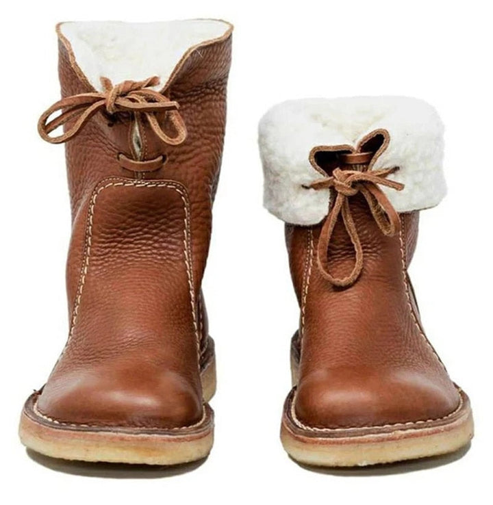 Pair of brown winter ankle boots showcased upright with soft interior lining