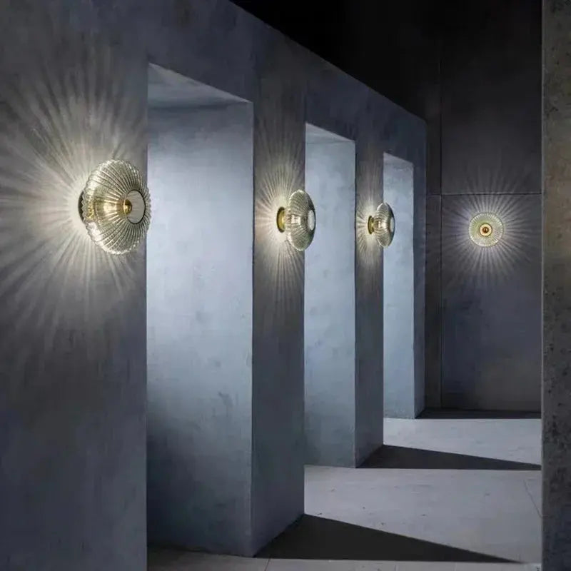 Modern nordic glass wall lamp illuminating a cozy living room interior