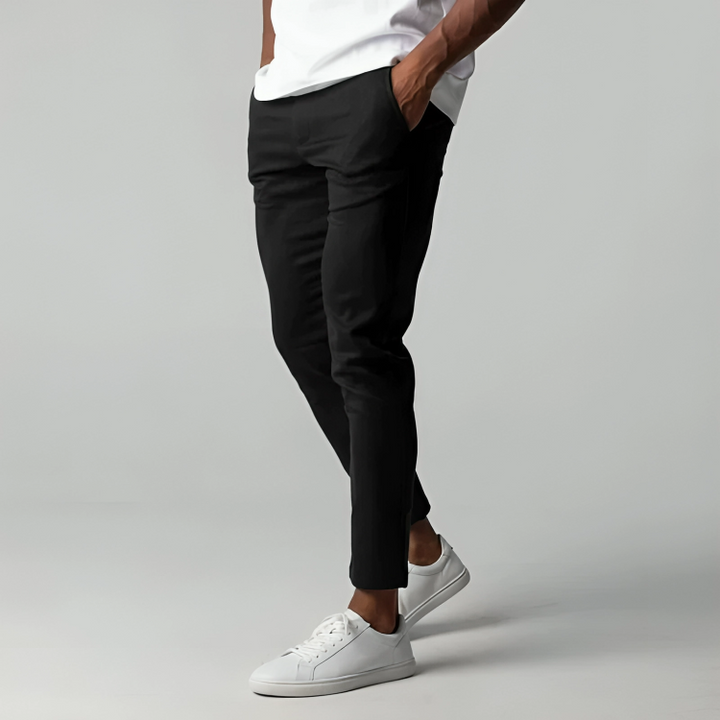 Side profile view of men's modern fit flex chino trousers in black, showing slim leg cut