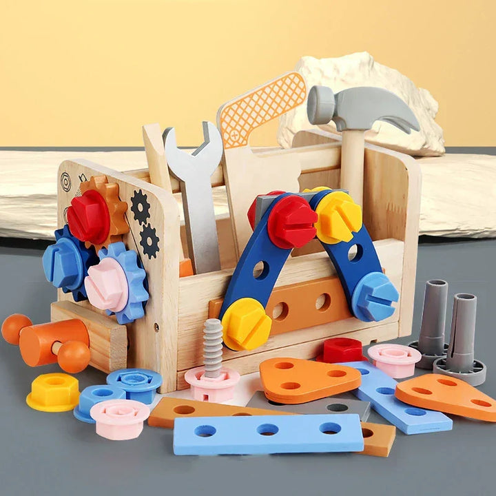 Wooden kids tool kit with colourful gears, bolts, and toy tools arranged around a wooden box
