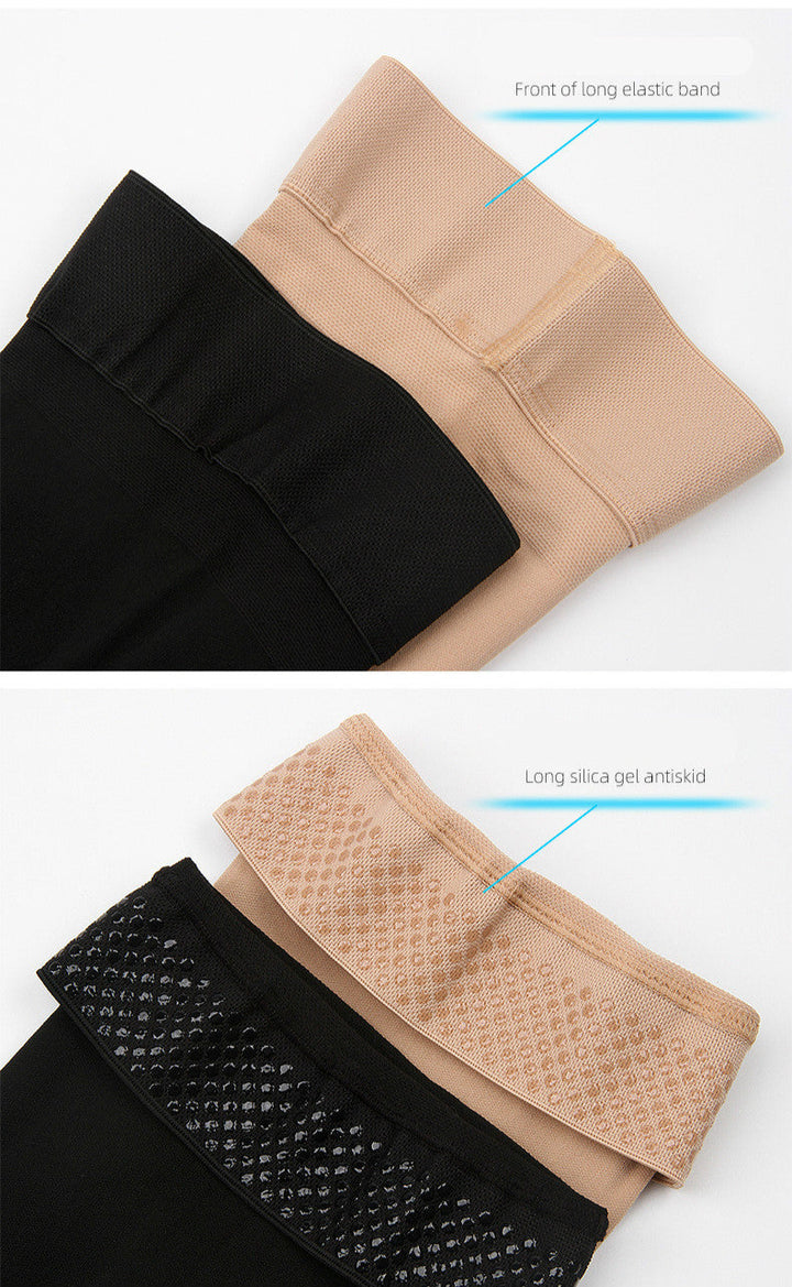 Pair of black unisex thigh high support socks laid flat on white surface