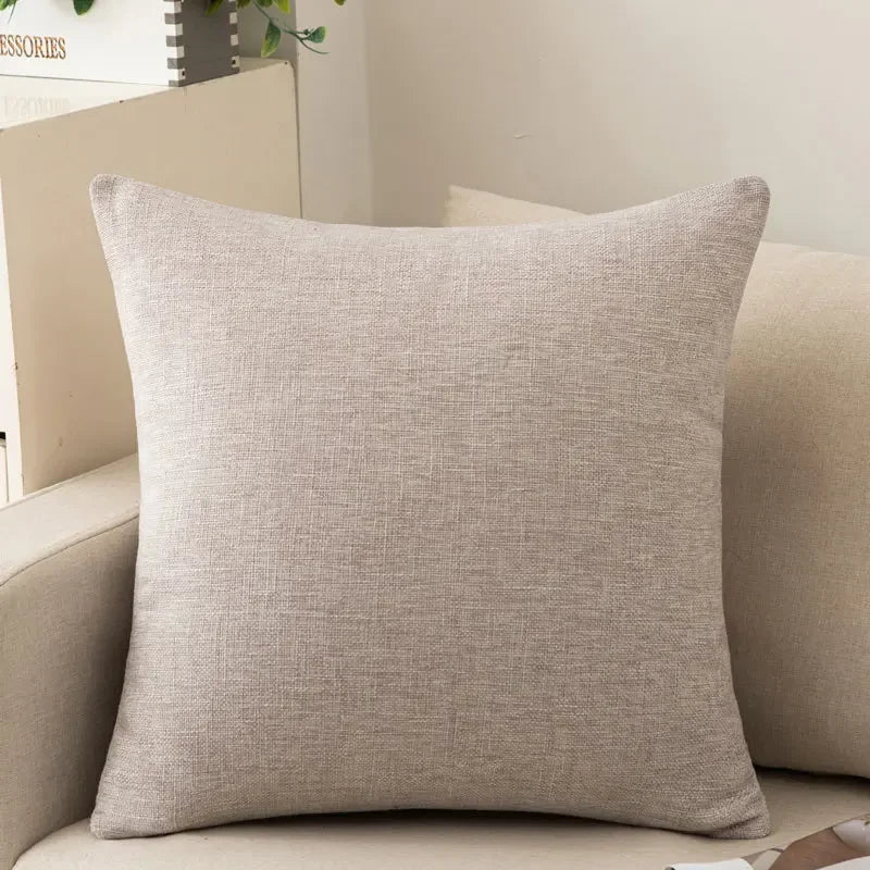 Light grey decorative cushion resting on a sofa