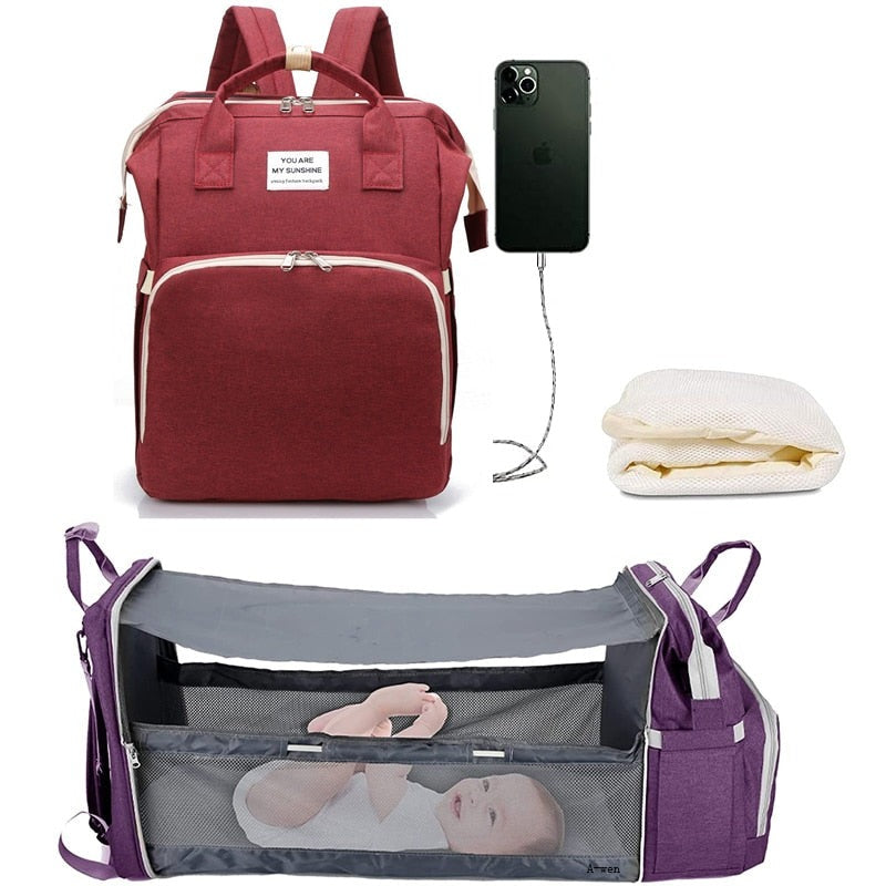Baby travel backpack with insulated bottle pockets to keep infant milk warm on the go.