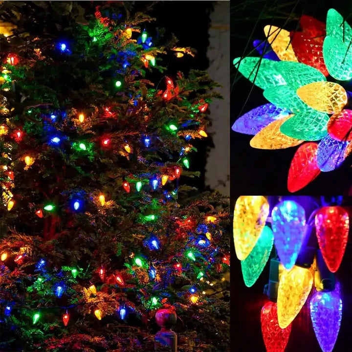 Illuminated festive garden tree decorated with colorful strawberry string lights