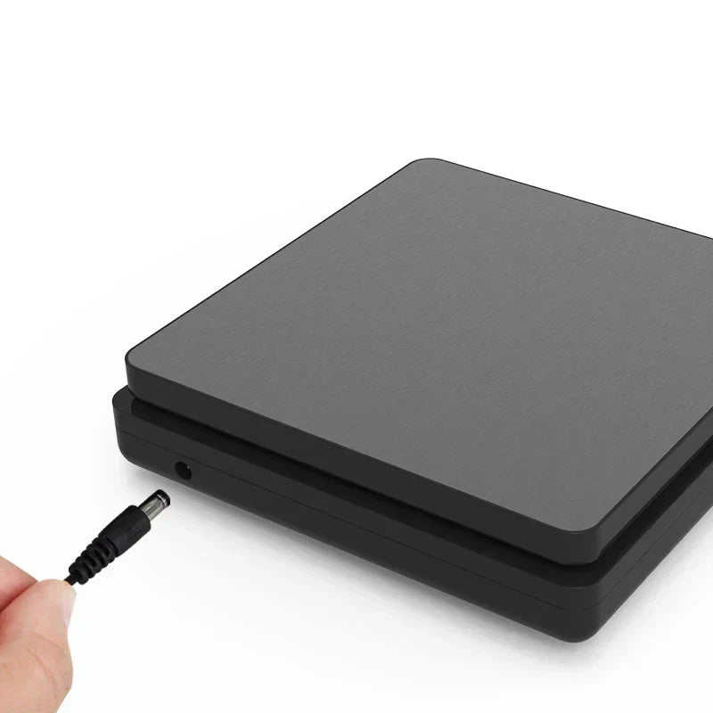 Digital kitchen scale plugged into a charging cable showcasing the side power port