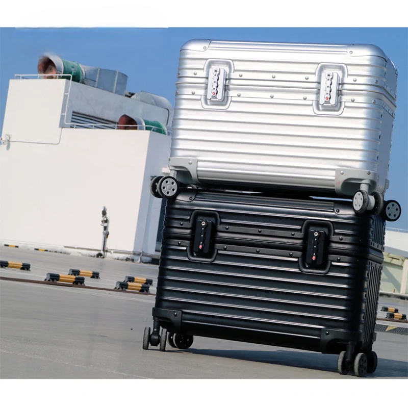 Silver and black Monaco travel cases stacked outdoors against a clear blue sky