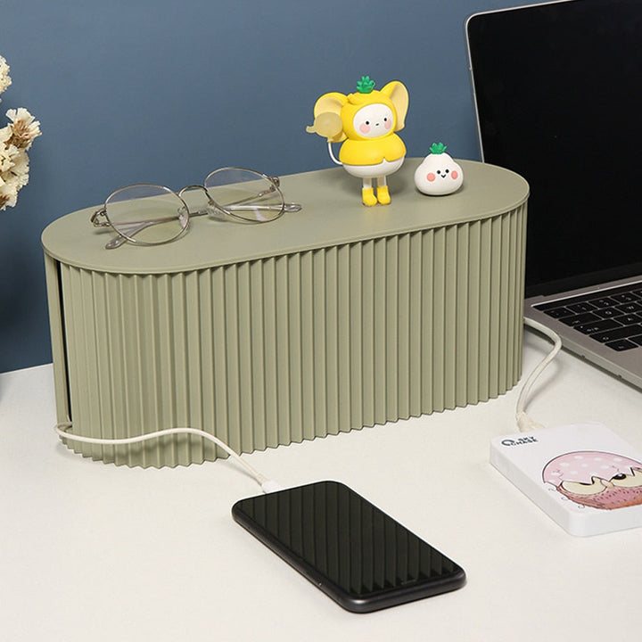 Green cable management box keeping desk cords neat and tidy