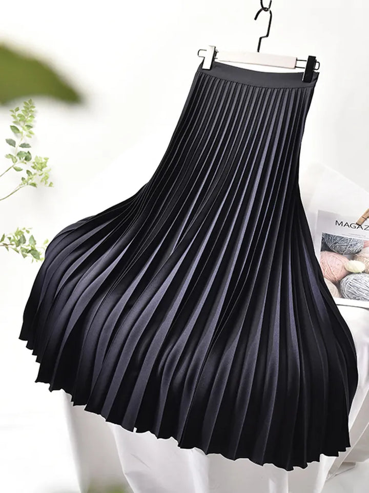 Black pleated elastic waist midi skirt hanging on display