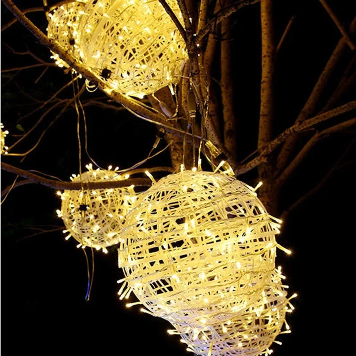 Rattan sphere string lights glowing softly for garden party decor and patio lighting