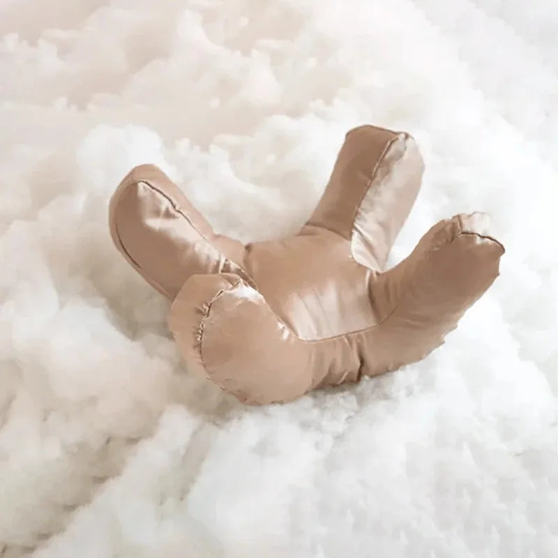 SilkRest face pillow in gold color showcasing unique ergonomic contour shape