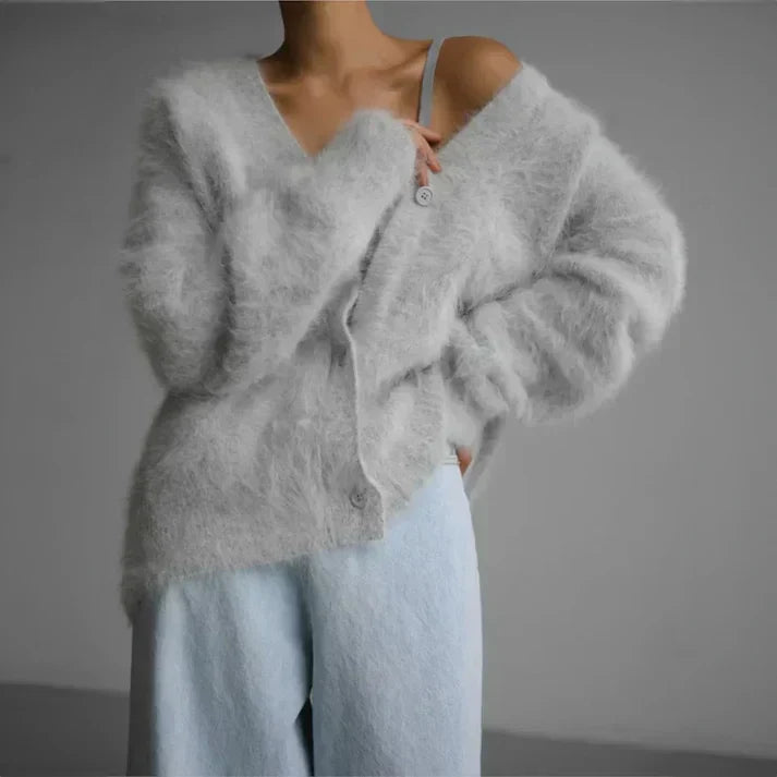Woman showcasing a light grey open knit cardigan outdoors