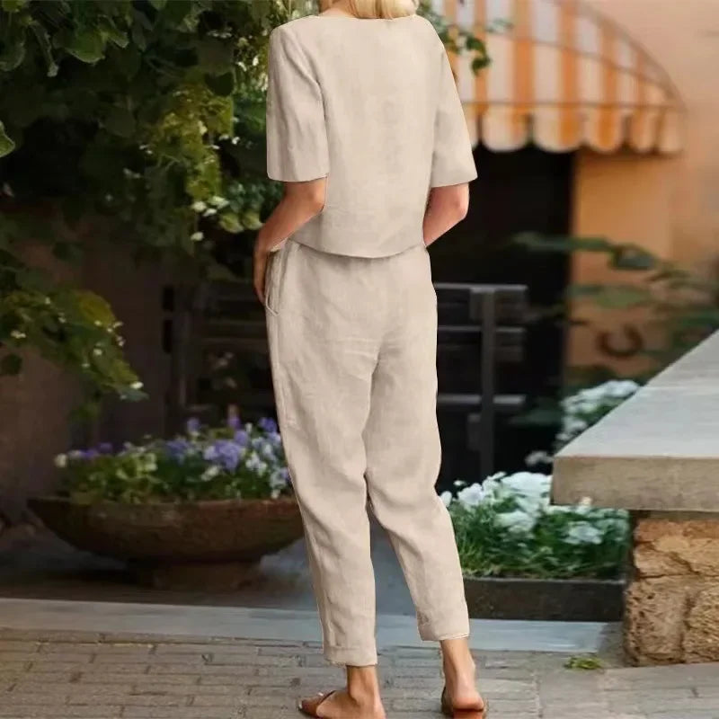 Back view of woman wearing soft beige two-piece outfit