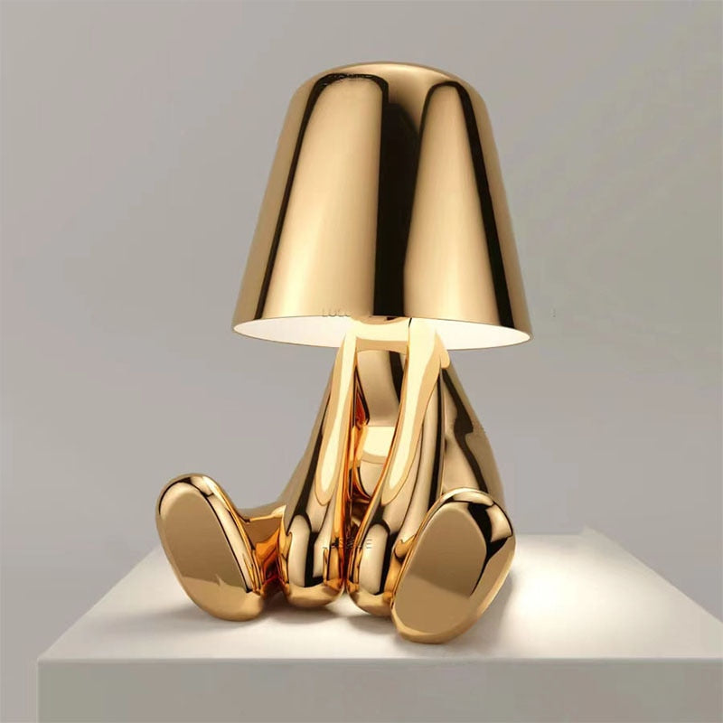 Gold wireless table lamp in relaxing sitting pose