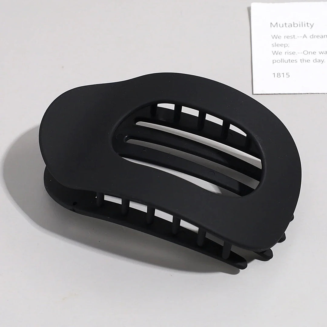 Minimalist oval hair accessory designed to lie flat against the head