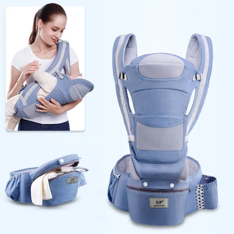 Mother wearing a blue ergonomic baby carrier holding an infant