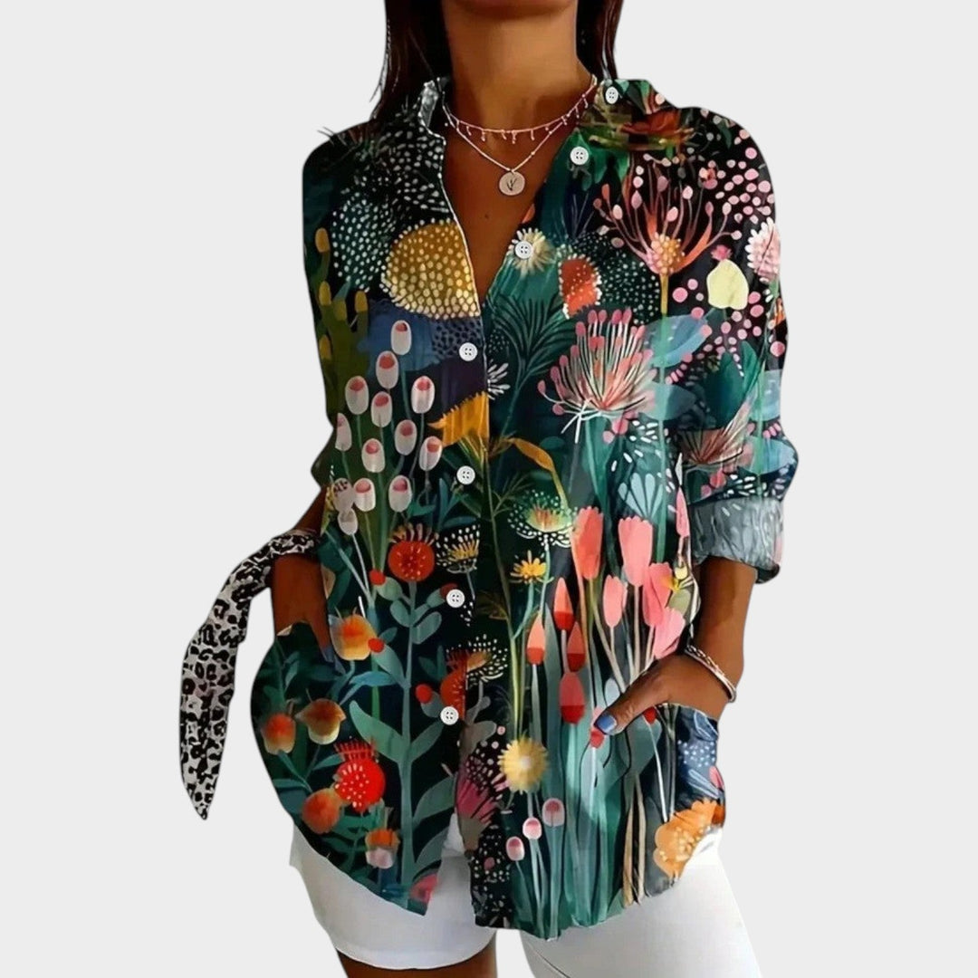 Woman wearing a green botanical floral print button-up shirt