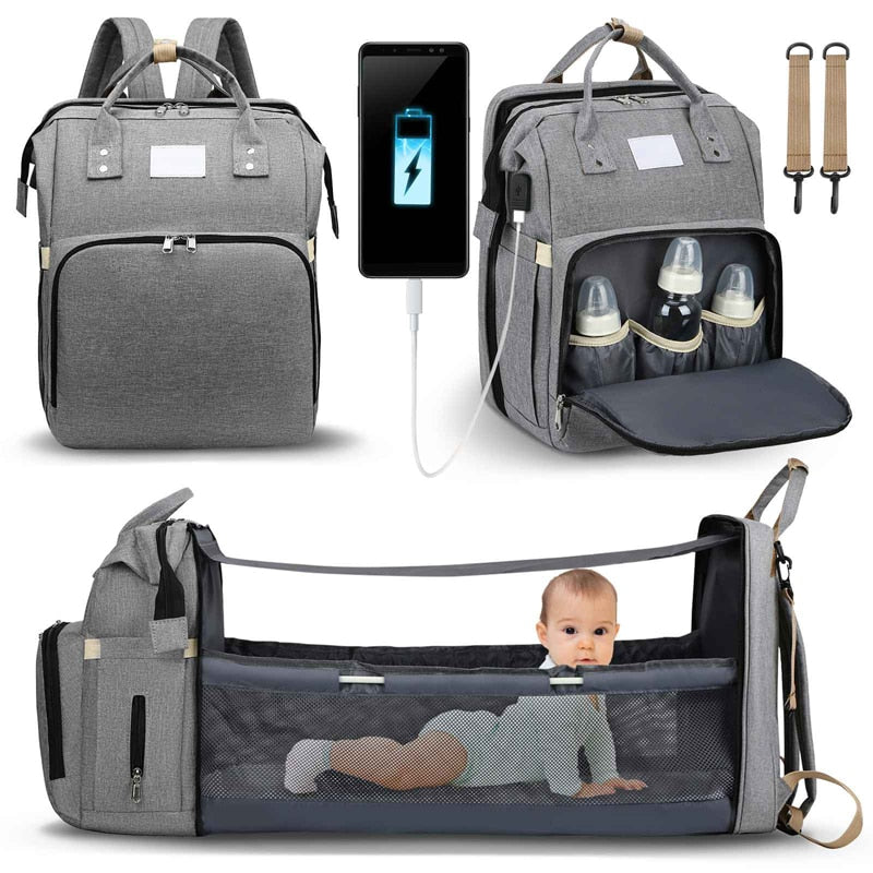 Grey 2-in-1 baby changing bag backpack shown with phone charging cable and bottles