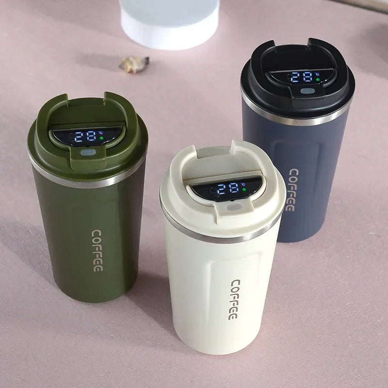 Three colorful smart thermal mugs with temperature display lids arranged together on a table
