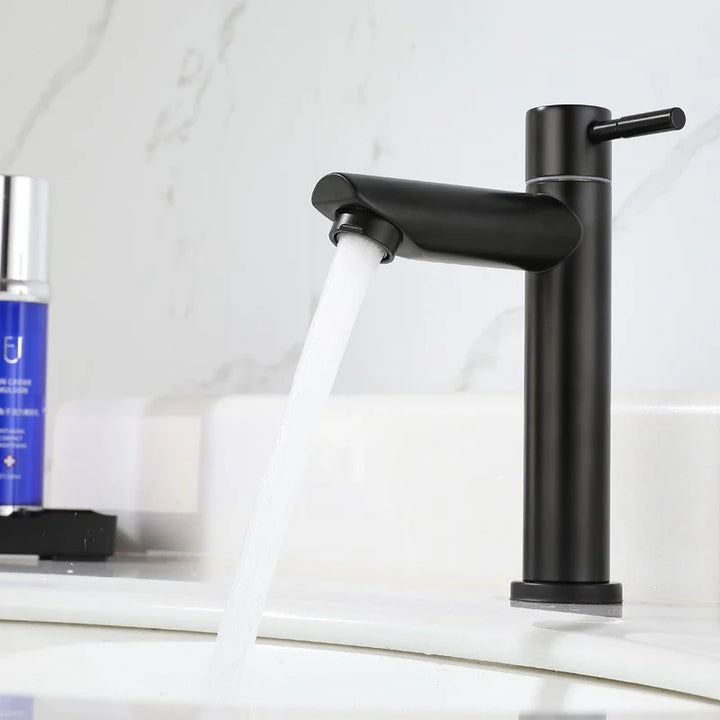 Black stainless steel basin faucet installed on a modern bathroom sink