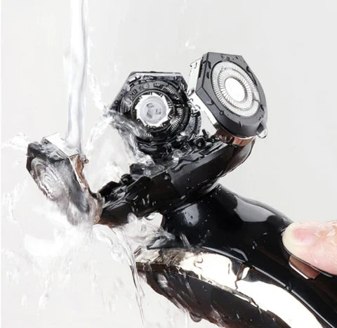 Waterproof electric shaver being rinsed under running tap water