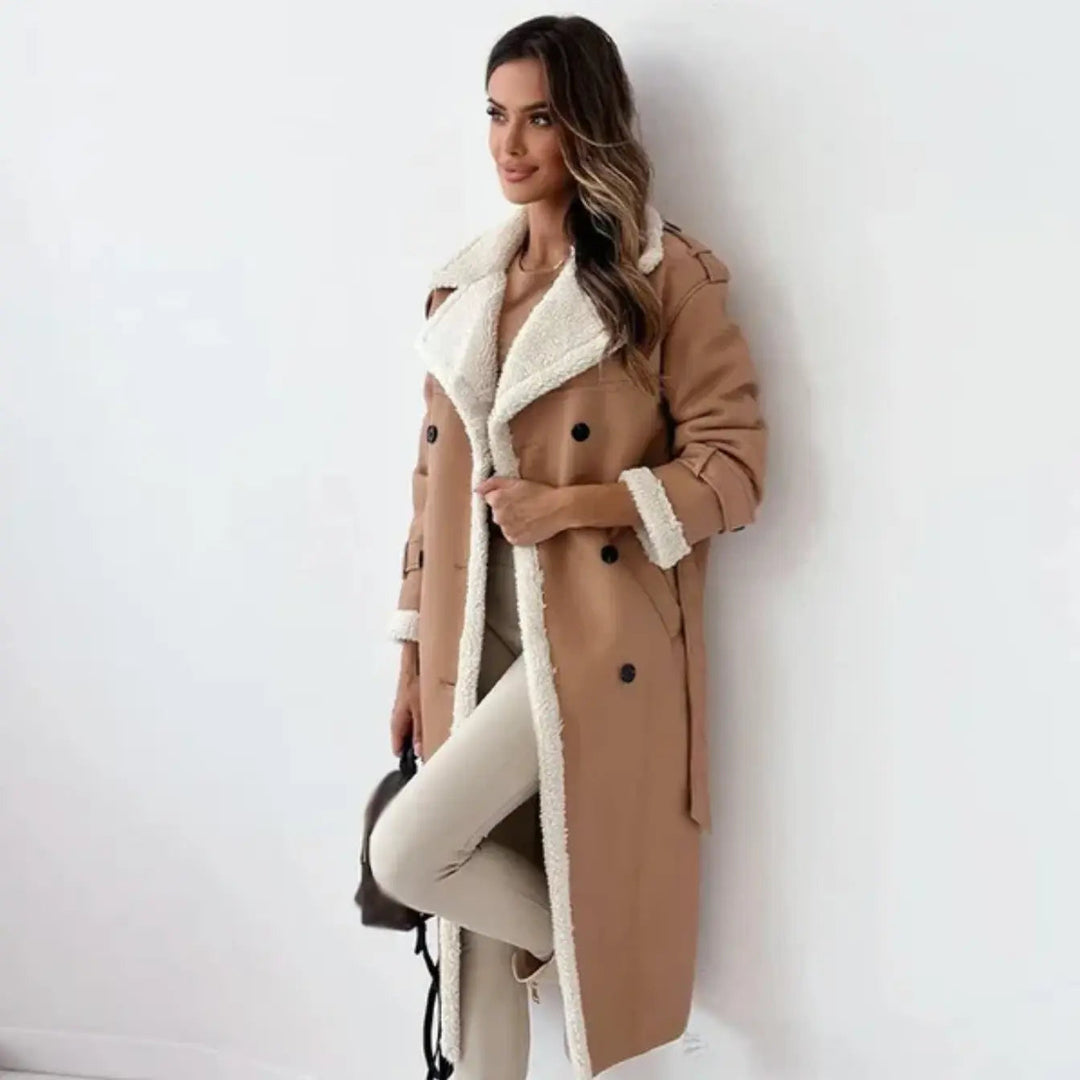 Woman posing in a khaki long winter coat with matching trousers and accessories