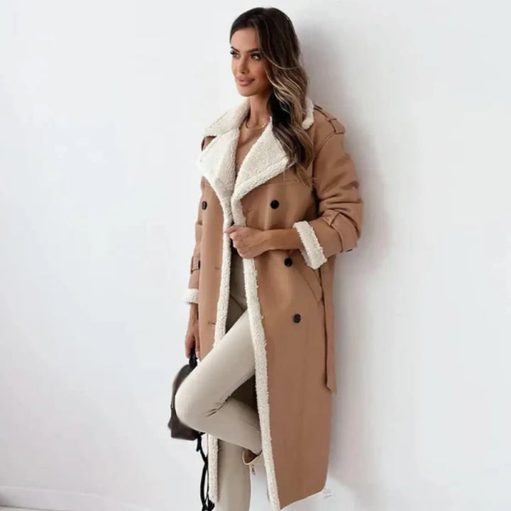 Woman posing in a khaki long winter coat with matching trousers and accessories