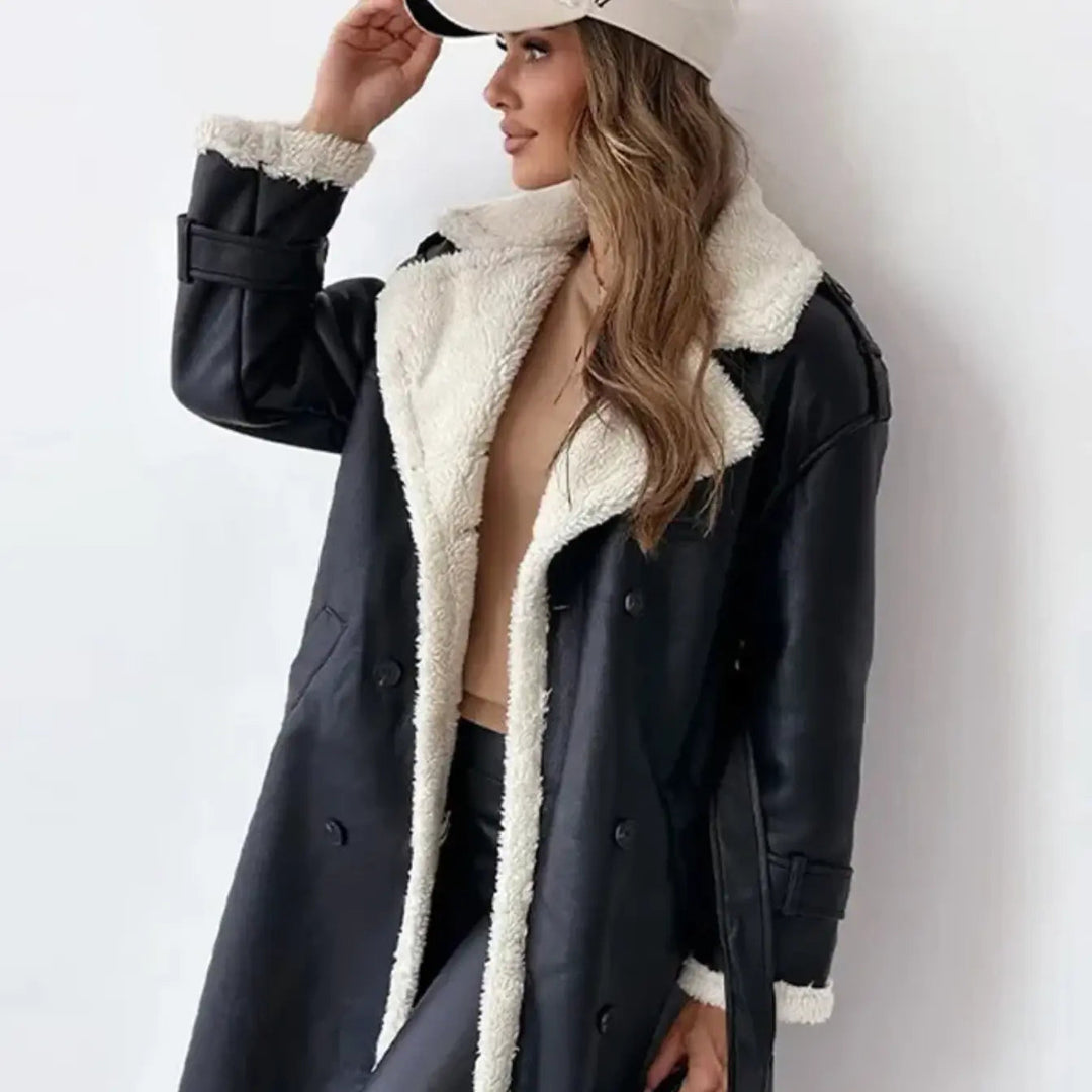 Close-up view of the black winter coat showing the teddy collar and button details
