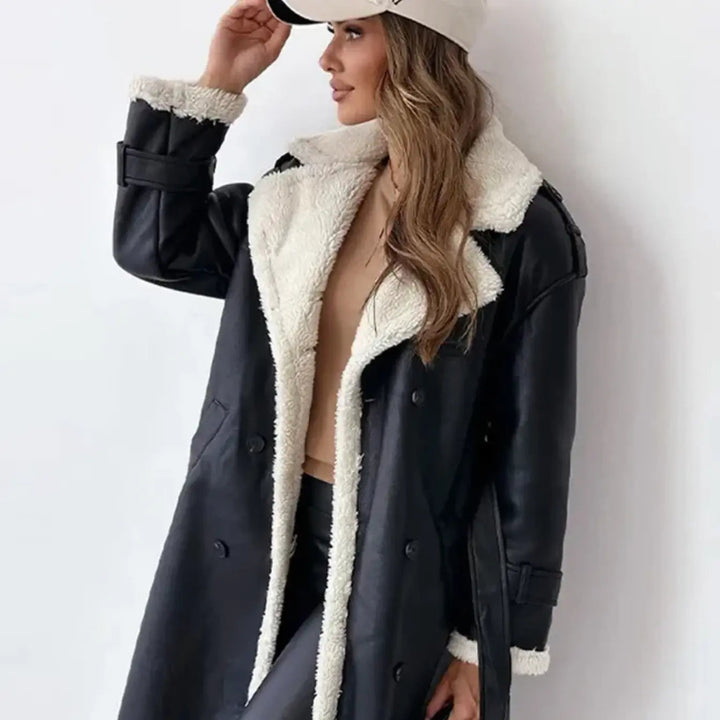 Close-up view of the black winter coat showing the teddy collar and button details