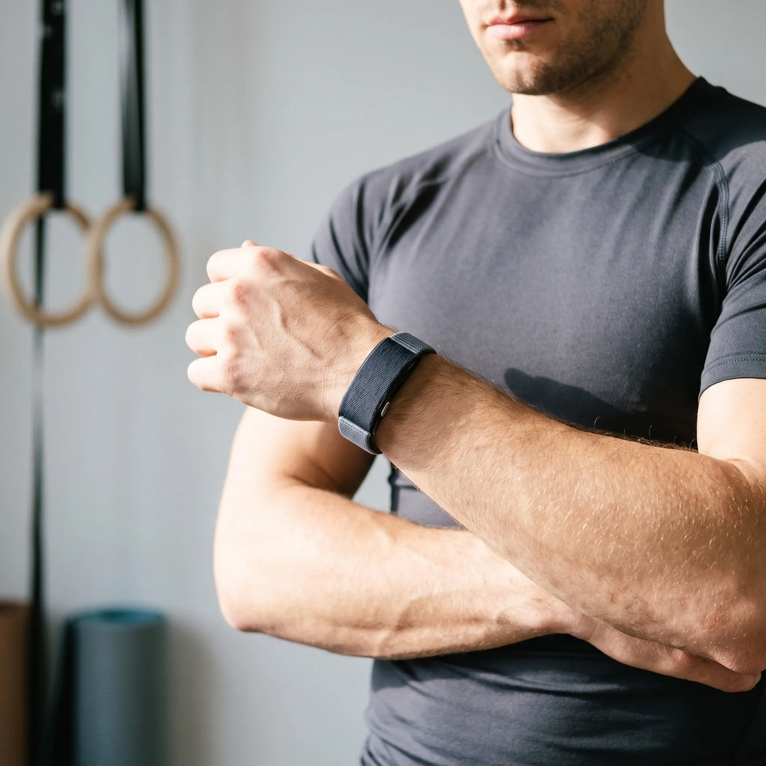 Man wearing a screenless fitness tracker bracelet on his wrist