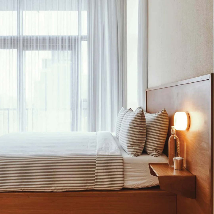 Close-up of the DimpleGlow LED wall light showing its sleek textured fixture