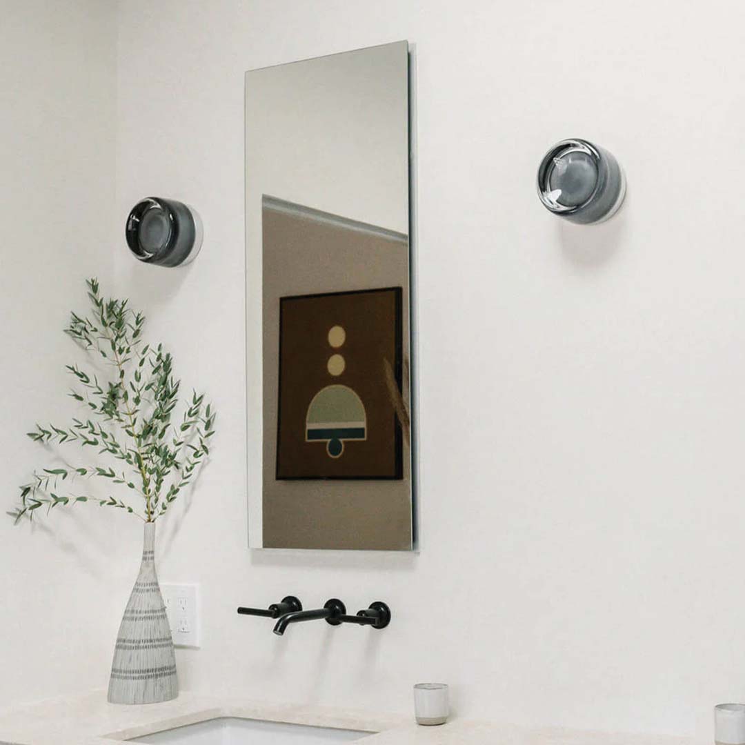 Smoke and white DimpleGlow wall lamps mounted in a modern bathroom setup