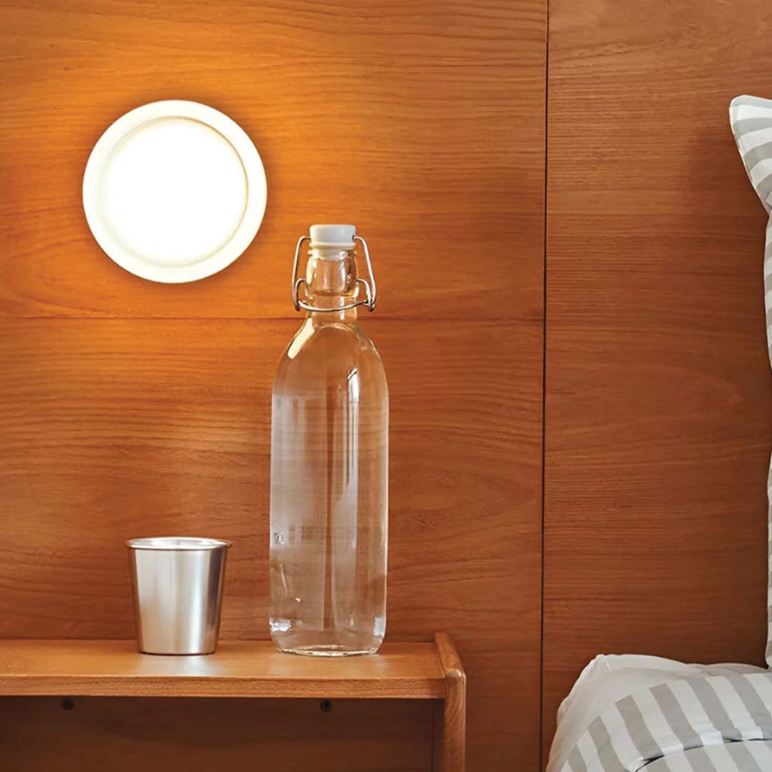 DimpleGlow compact modern wall lamp emitting warm LED light in a hallway