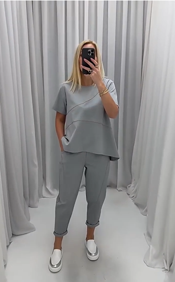 Full view of woman modeling the gray two-piece set in a studio setting