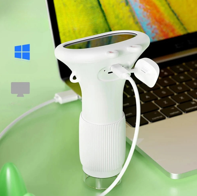 White WonderZoom kids microscope connected to a laptop via USB cable for data transfer