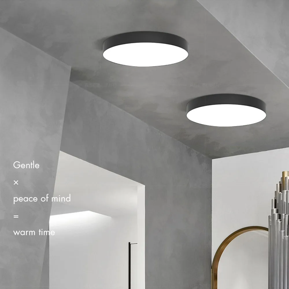 Interior room view showing warm glow from a modern round LED ceiling lamp fixture