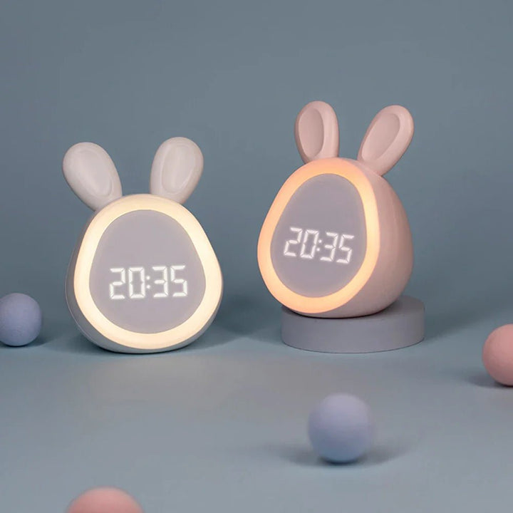 Pink and white bunny alarm clocks displayed together on a table
