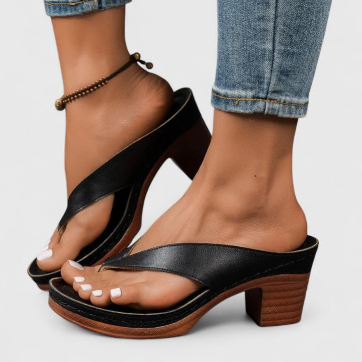 Pair of stylish women's block heel sandals displayed on a neutral surface