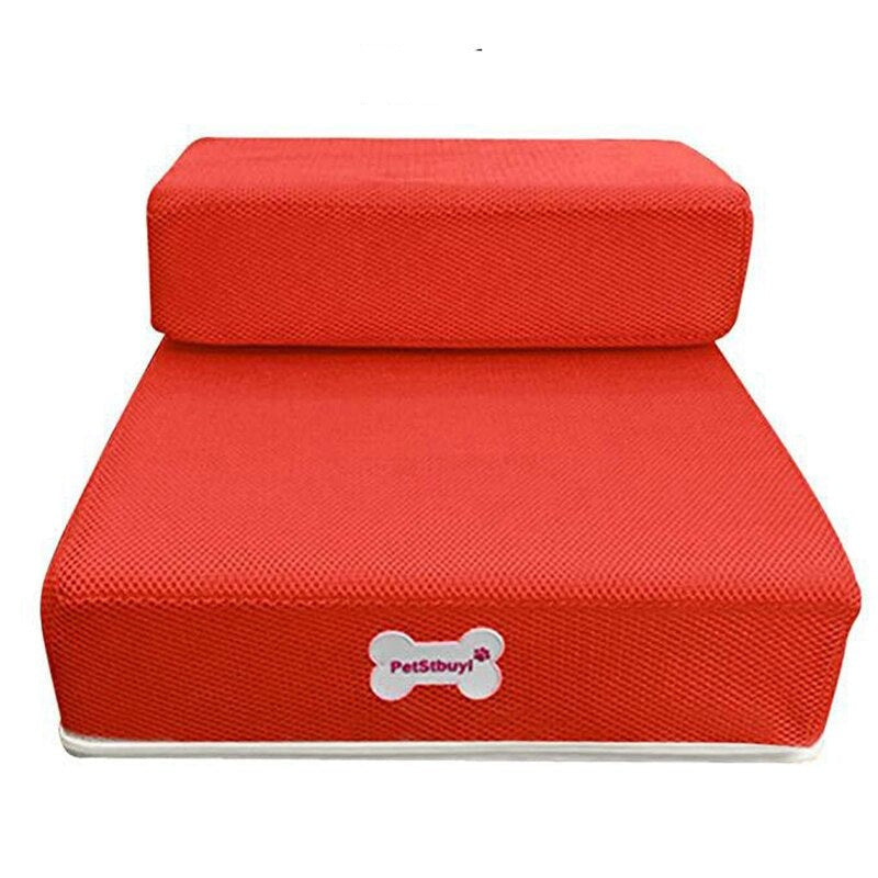 Portable dog steps for travel and home use next to bedroom mattress