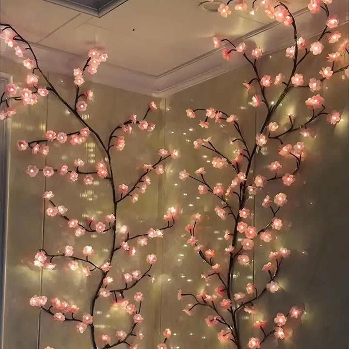 Close-up view of lit cherry blossom branches mounted on a corner wall