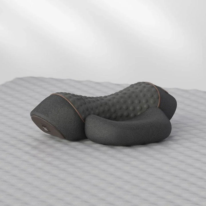 Electric heating neck massager pillow in dark grey on textured surface